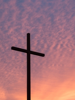 silhouette of large cross during daytime